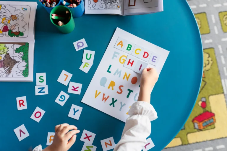 top-view-kid-learning-letters-kindergarten